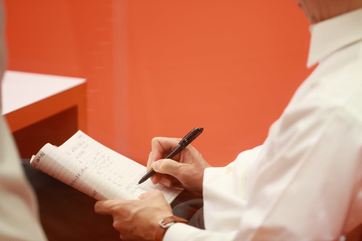 General person writing notes meeting conference
