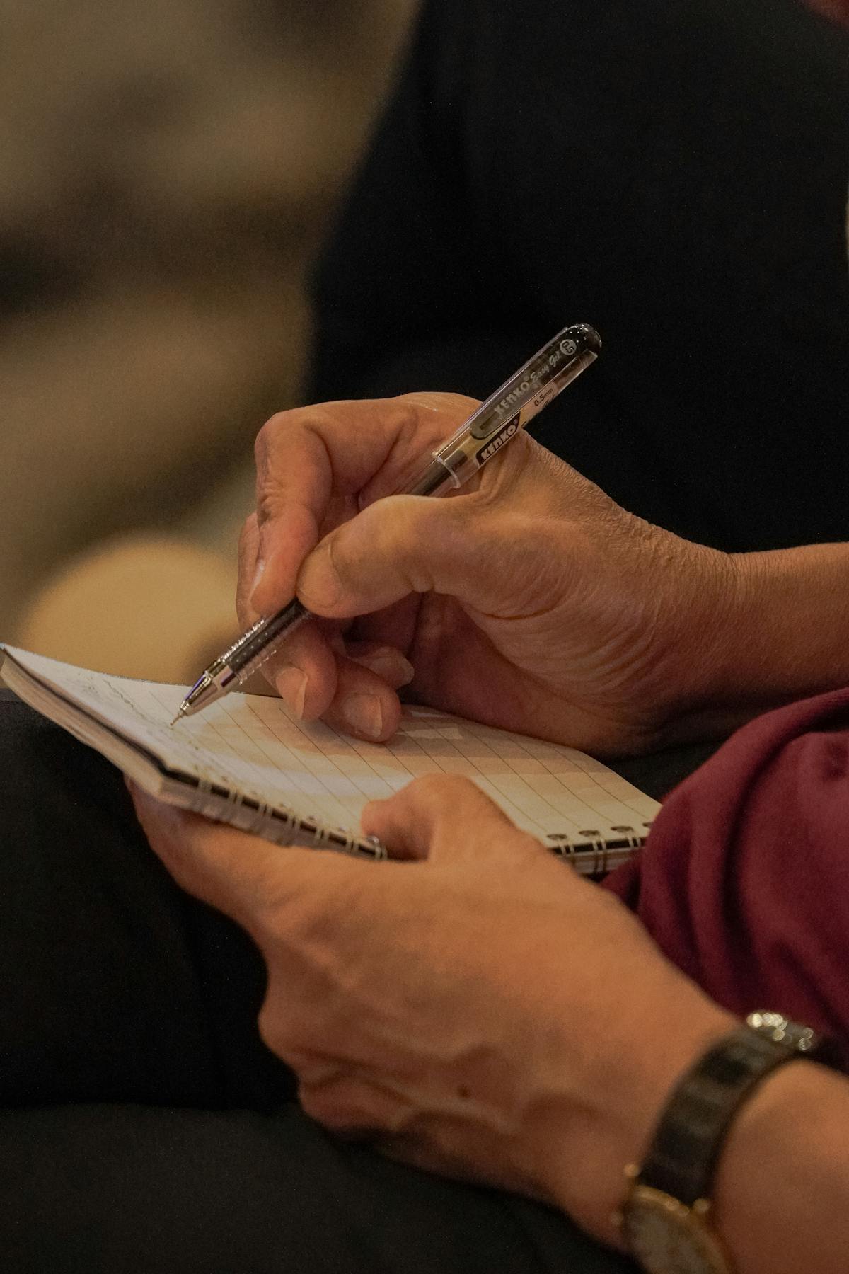 General person writing notes meeting conference